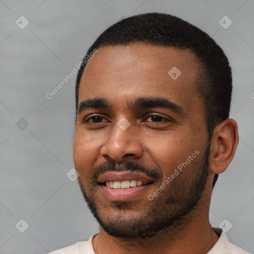 Joyful black young-adult male with short  black hair and brown eyes