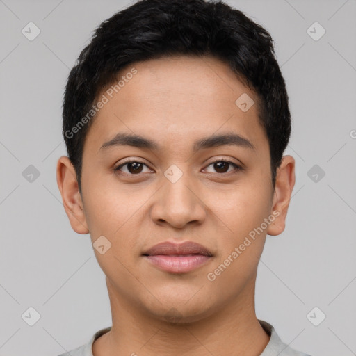 Joyful latino young-adult male with short  black hair and brown eyes