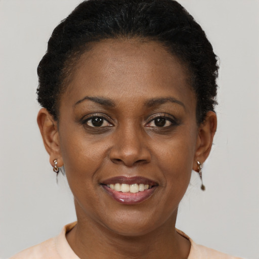 Joyful black adult female with short  brown hair and brown eyes