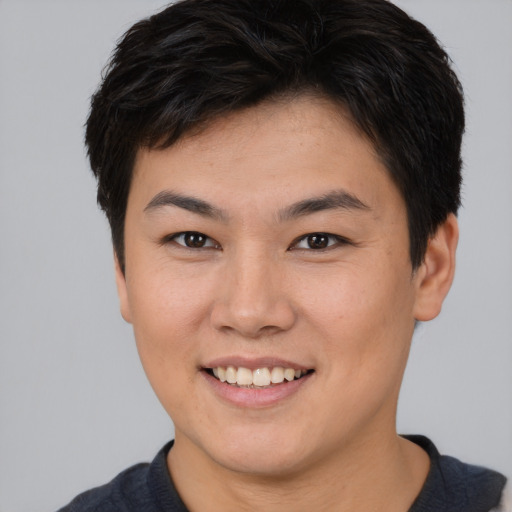 Joyful asian young-adult female with short  brown hair and brown eyes