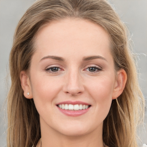 Joyful white young-adult female with long  brown hair and grey eyes