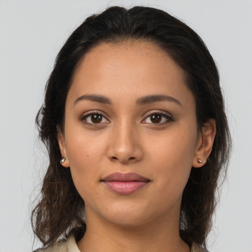 Joyful latino young-adult female with long  brown hair and brown eyes