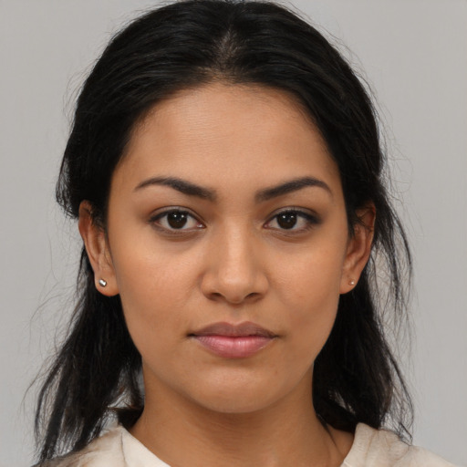 Joyful latino young-adult female with medium  brown hair and brown eyes