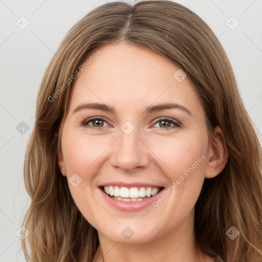 Joyful white young-adult female with long  brown hair and green eyes