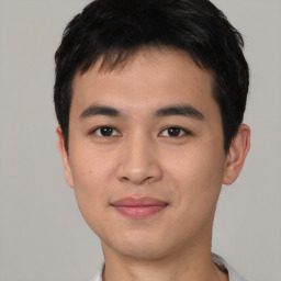 Joyful asian young-adult male with short  black hair and brown eyes