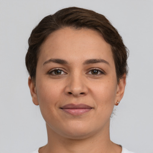 Joyful white young-adult female with short  brown hair and brown eyes