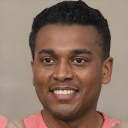Joyful latino young-adult male with short  black hair and brown eyes