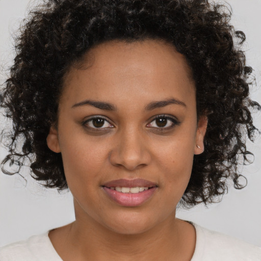 Joyful black young-adult female with medium  brown hair and brown eyes