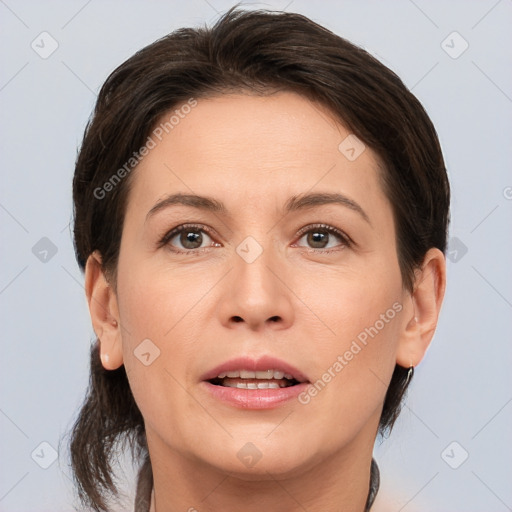 Joyful white adult female with medium  brown hair and brown eyes