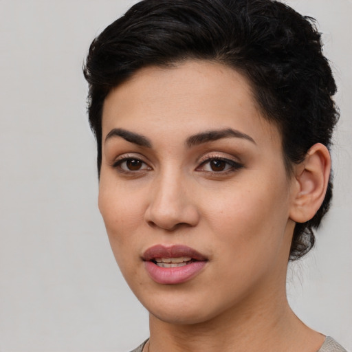 Joyful latino young-adult female with short  brown hair and brown eyes