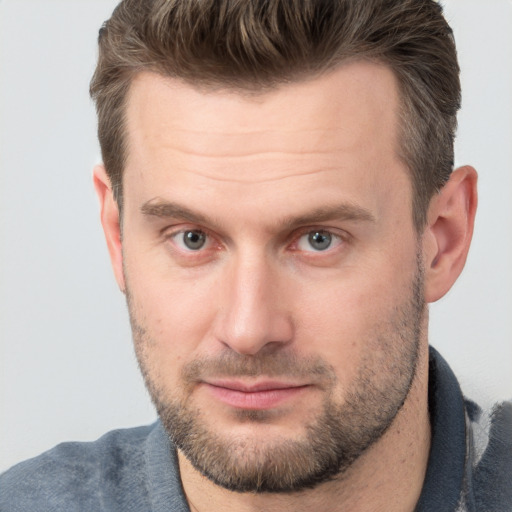 Joyful white adult male with short  brown hair and brown eyes