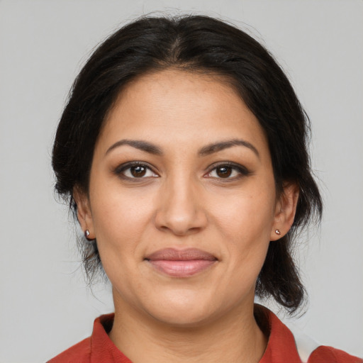 Joyful latino young-adult female with medium  brown hair and brown eyes