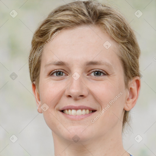 Joyful white young-adult female with medium  brown hair and green eyes