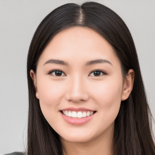 Joyful white young-adult female with long  black hair and brown eyes