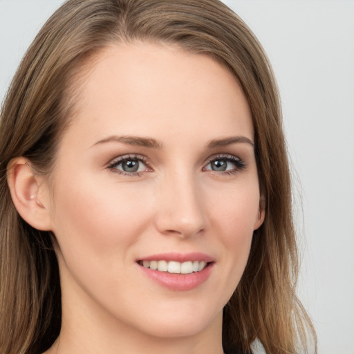 Joyful white young-adult female with long  brown hair and grey eyes