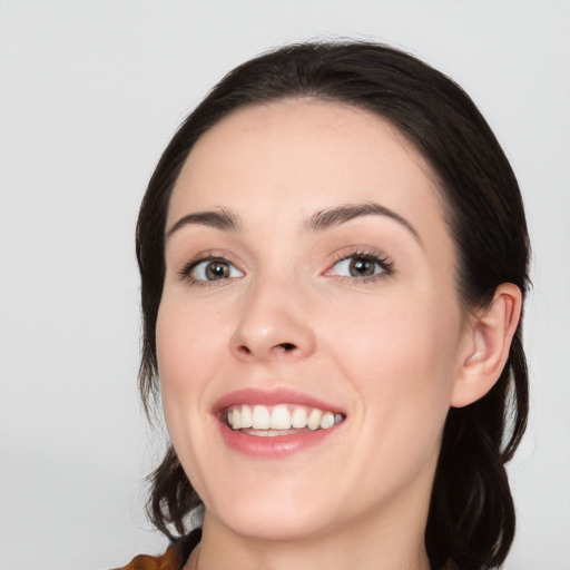 Joyful white young-adult female with medium  black hair and brown eyes