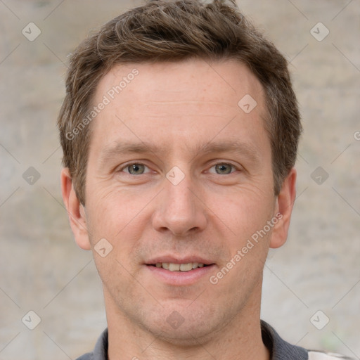 Joyful white adult male with short  brown hair and grey eyes