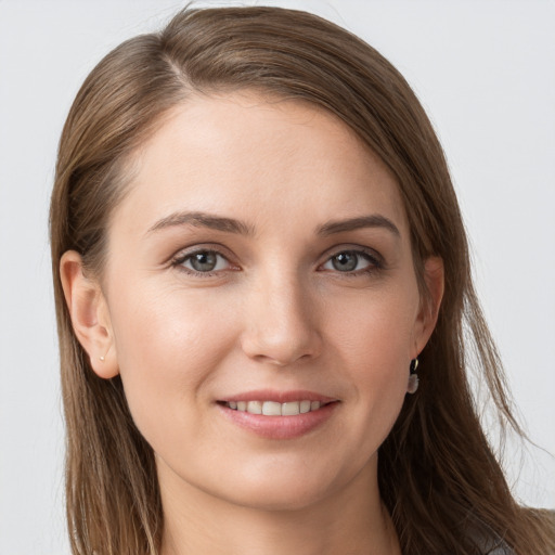 Joyful white young-adult female with long  brown hair and grey eyes