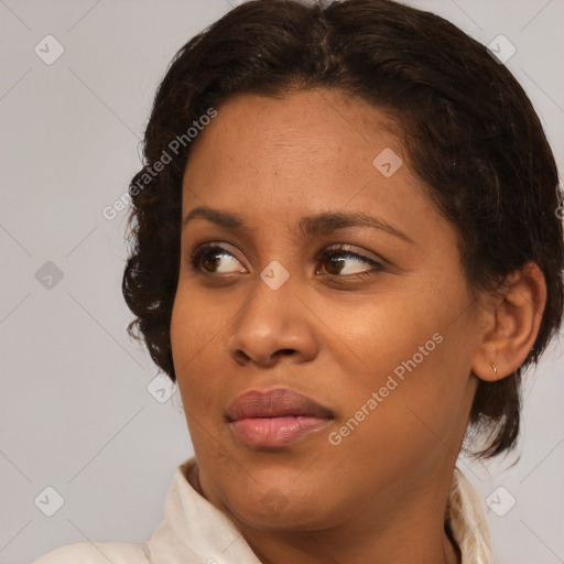 Joyful black young-adult female with medium  brown hair and brown eyes