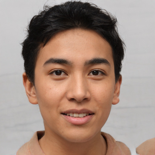 Joyful asian young-adult male with short  brown hair and brown eyes