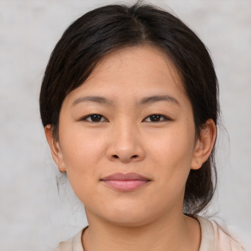 Joyful asian young-adult female with medium  brown hair and brown eyes