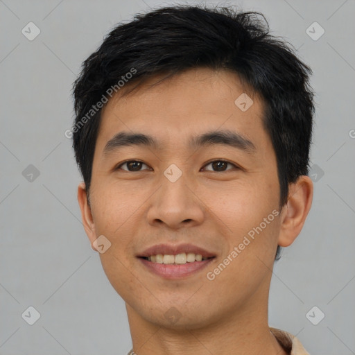 Joyful asian young-adult male with short  brown hair and brown eyes