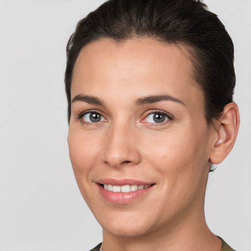 Joyful white young-adult female with short  brown hair and brown eyes