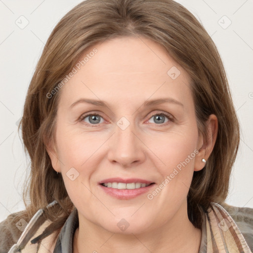 Joyful white adult female with long  brown hair and grey eyes