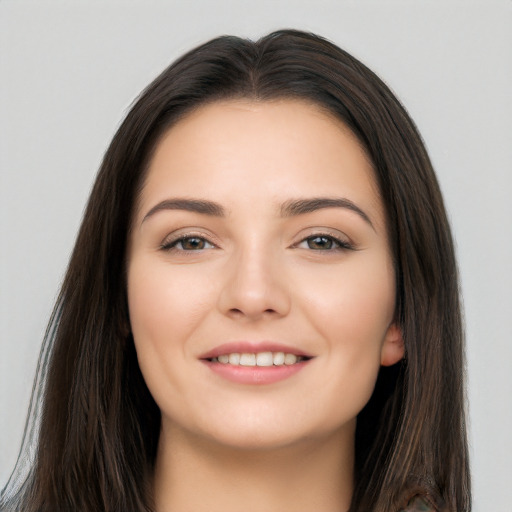 Joyful white young-adult female with long  brown hair and brown eyes