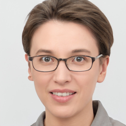 Joyful white young-adult female with short  brown hair and grey eyes