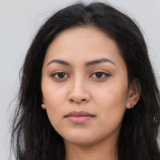 Neutral latino young-adult female with long  brown hair and brown eyes