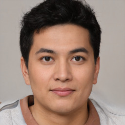 Joyful asian young-adult male with short  brown hair and brown eyes