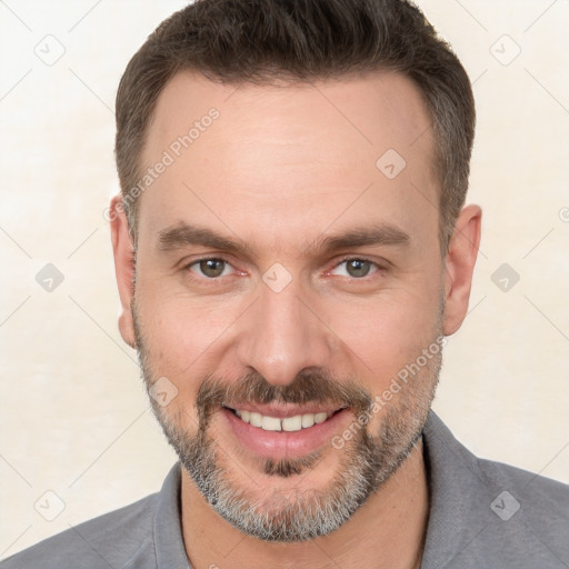 Joyful white adult male with short  brown hair and brown eyes