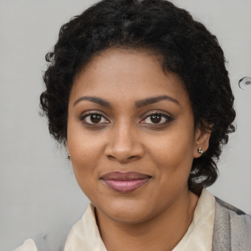Joyful black young-adult female with medium  brown hair and brown eyes