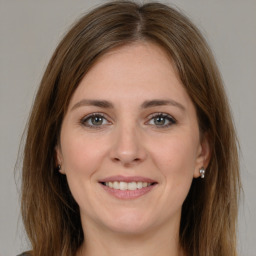 Joyful white young-adult female with long  brown hair and brown eyes