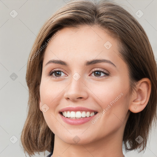 Joyful white young-adult female with medium  brown hair and green eyes