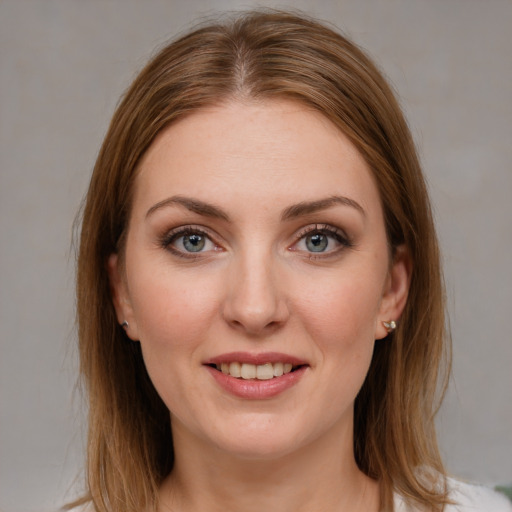 Joyful white young-adult female with medium  brown hair and blue eyes