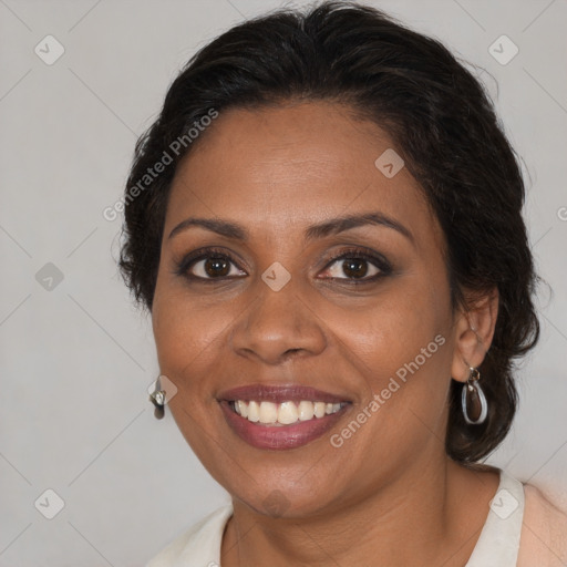 Joyful black adult female with medium  brown hair and brown eyes