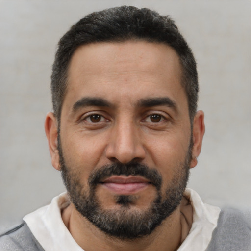 Joyful black adult male with short  black hair and brown eyes