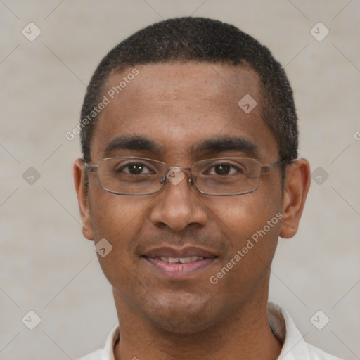 Joyful black young-adult male with short  black hair and brown eyes