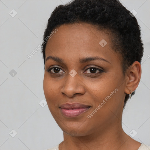 Joyful black young-adult female with short  black hair and brown eyes