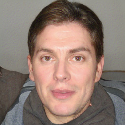 Joyful white adult male with short  brown hair and grey eyes