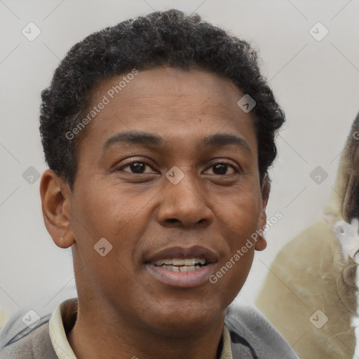 Joyful black young-adult male with short  brown hair and brown eyes