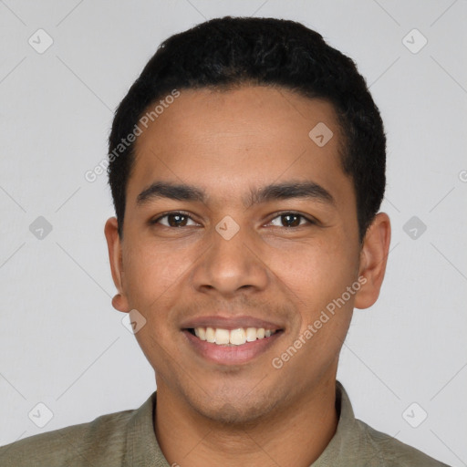 Joyful latino young-adult male with short  black hair and brown eyes