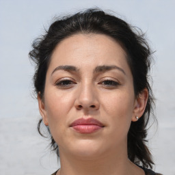 Joyful white adult female with medium  brown hair and brown eyes