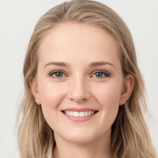 Joyful white young-adult female with long  brown hair and blue eyes