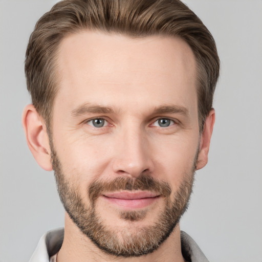 Joyful white adult male with short  brown hair and grey eyes