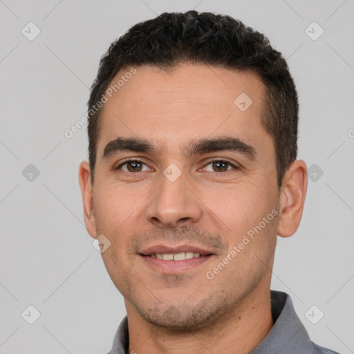 Joyful white young-adult male with short  brown hair and brown eyes