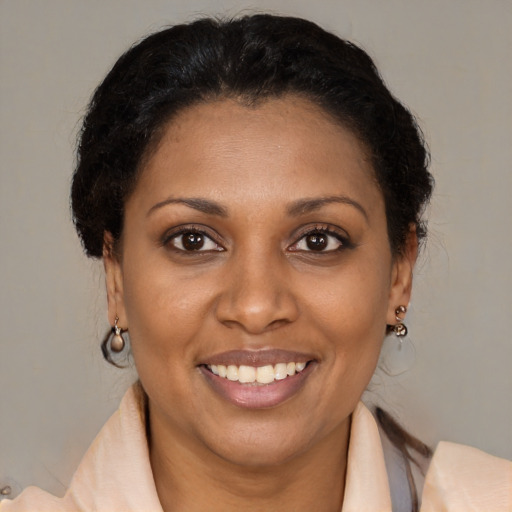 Joyful latino adult female with medium  brown hair and brown eyes