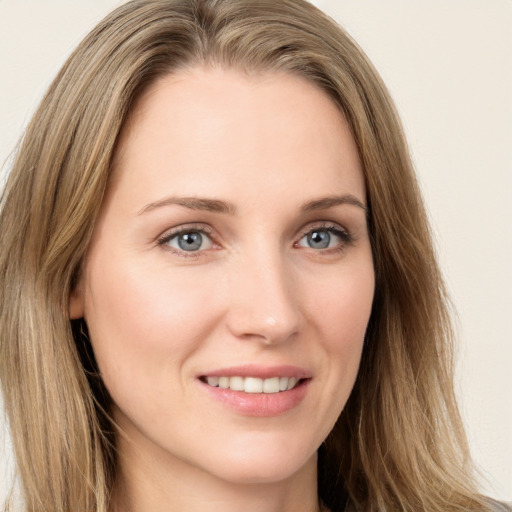 Joyful white young-adult female with long  brown hair and blue eyes